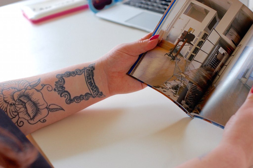 tattooarmslookingatdesignbook